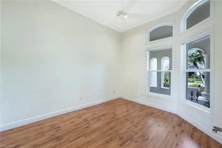 Spare room featuring hardwood / wood-style floors, ornamental molding, and ceiling fan