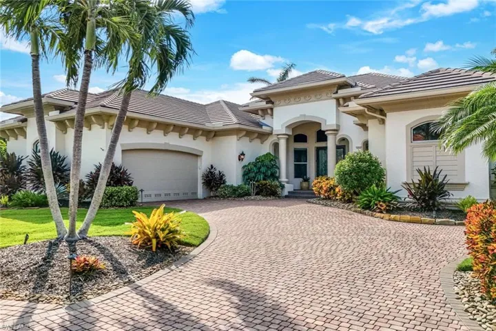Mediterranean / spanish-style house featuring a front lawn and a garage