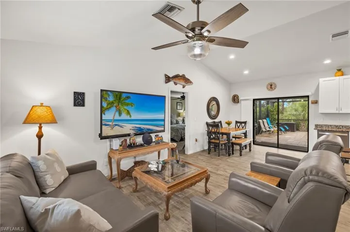 Living area walks right out to the pool with sliding glass doors.