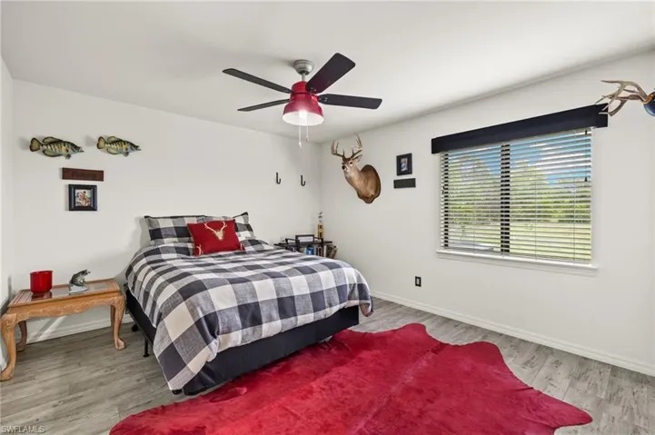 Large guest bedroom with LVT flooring.
