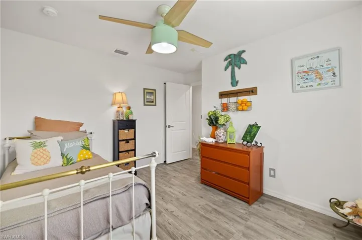 Guest room with beautiful modern ceiling fan.  In this photo, the closet is behind the open entry door.