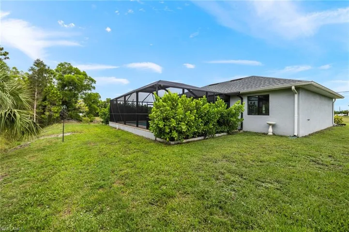 Pool area is private with beautiful clusia hedges obstructing view of neighboring properties.  There are also gutters around the entire home directing water away from the house's foundation.