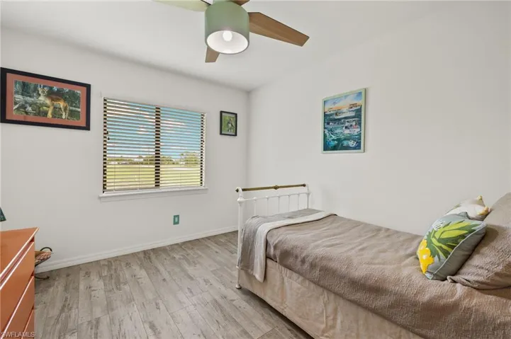 Large guest bedroom with LVT flooring.