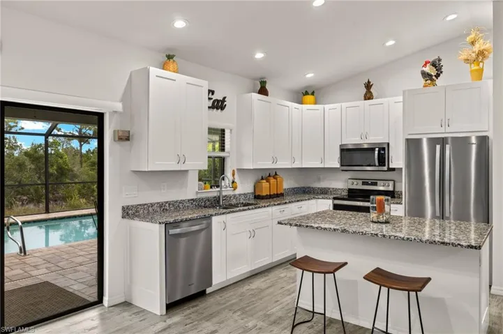 Kitchen features granite counter tops and stainless steel appliances.