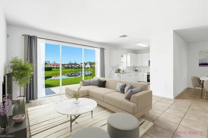 Living space with large sliding glass doors, tile flooring, and white walls