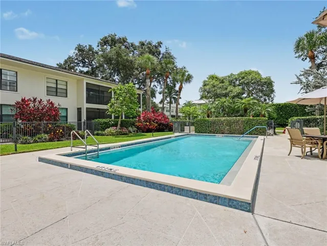 Rectangular swimming pool with a blue tile waterline and light-colored coping