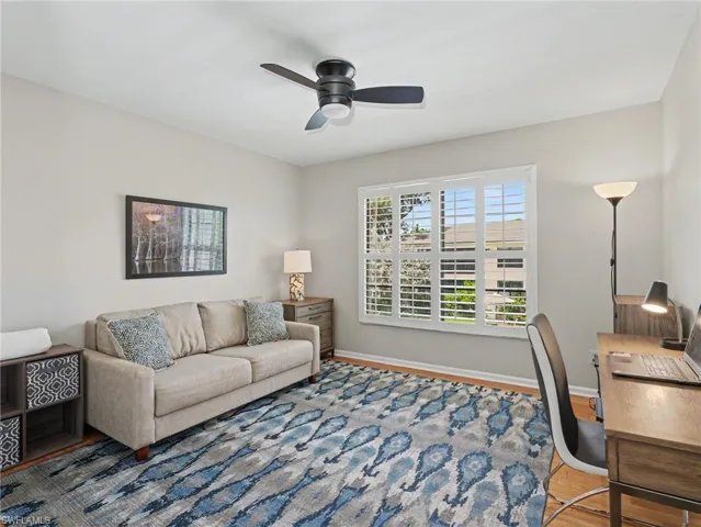 Neutral wall tones complement the wood-finish flooring
