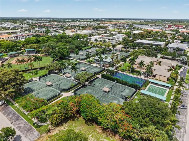 Extensive recreational facilities featuring multiple hard-surface tennis courts, a basketball court, and a turf field