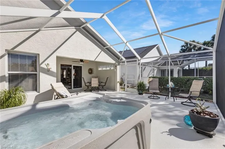 View of spa in screen-enclosed patio
