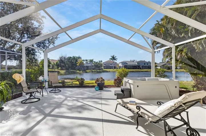View of patio with screen enclosure with a water view