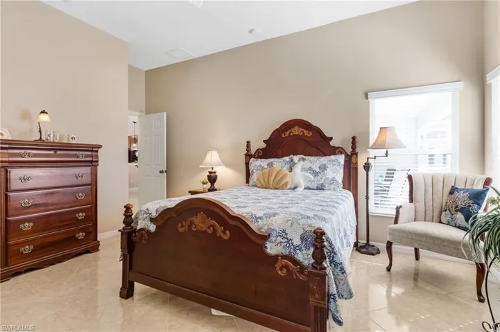 Bedroom featuring light tile patterned flooring and baseboards
