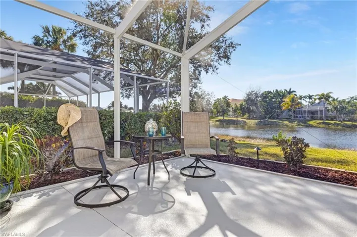 View of patio featuring a lanai, a water view