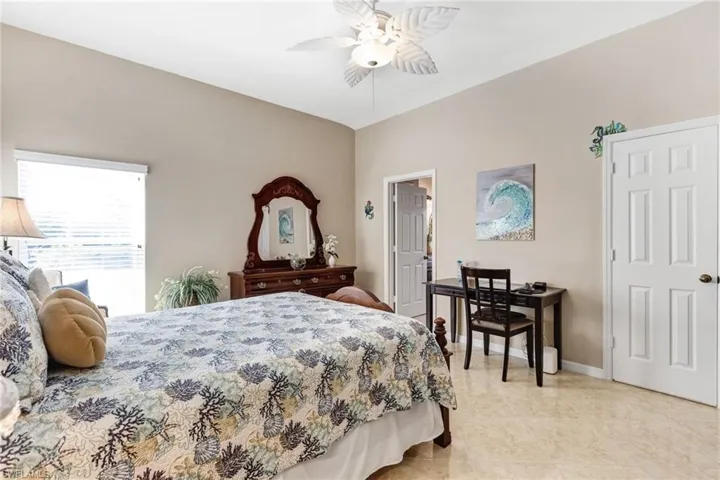 Bedroom featuring ceiling fan and baseboards