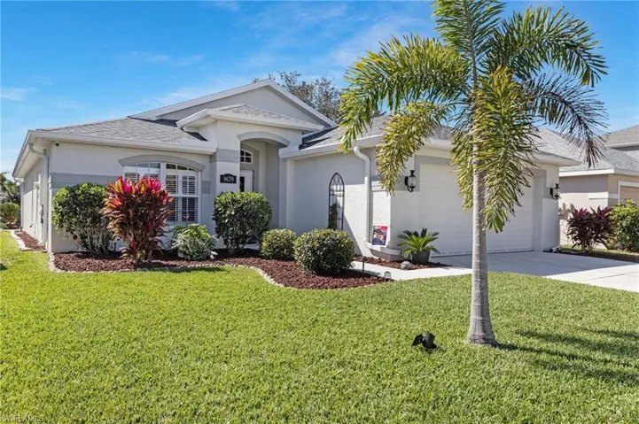 Ranch-style house with a front yard, stucco siding, concrete driveway, a garage, and a shingled roof