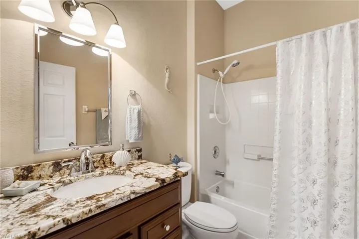 Full bathroom with shower / bath combo, vanity