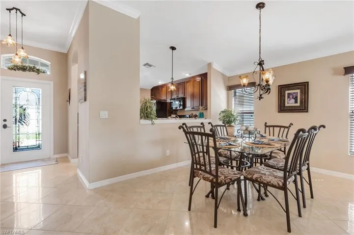Dining space featuring a chandelier and crown molding