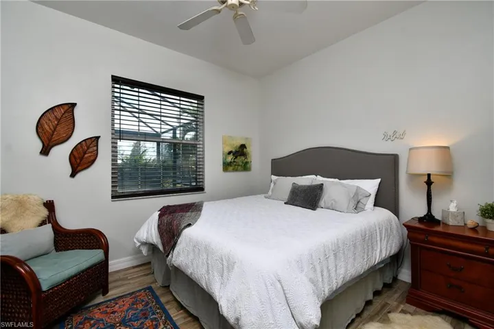 Bedroom featuring wood-type flooring and ceiling fan