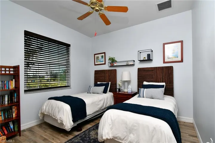 Bedroom with ceiling fan and hardwood / wood-style floors
