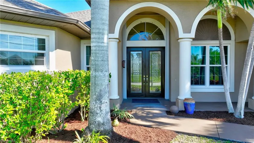 Property entrance featuring french doors