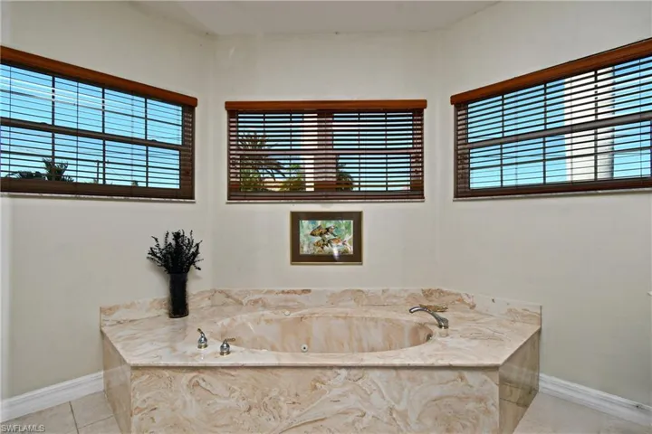 Bathroom featuring tile patterned floors and a washtub