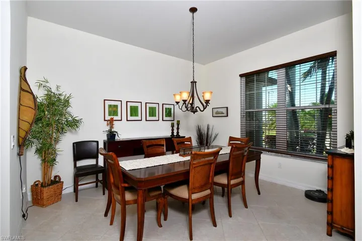 Tiled dining room featuring a notable chandelier