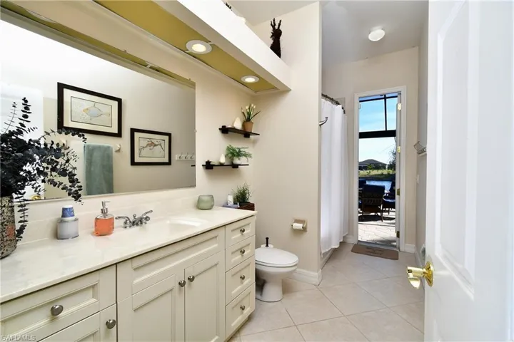 Bathroom with tile patterned floors, vanity, and toilet