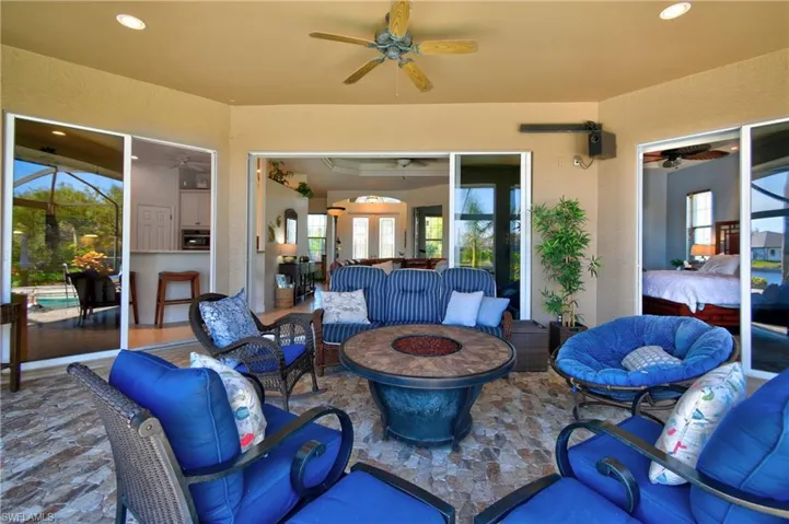 View of patio / terrace featuring ceiling fan and an outdoor living space with a fire pit
