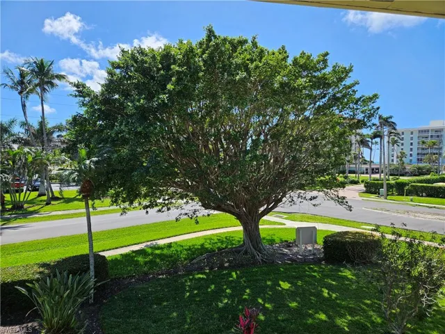 View of landscaping from the front of the unit, and a small view of the Gulf