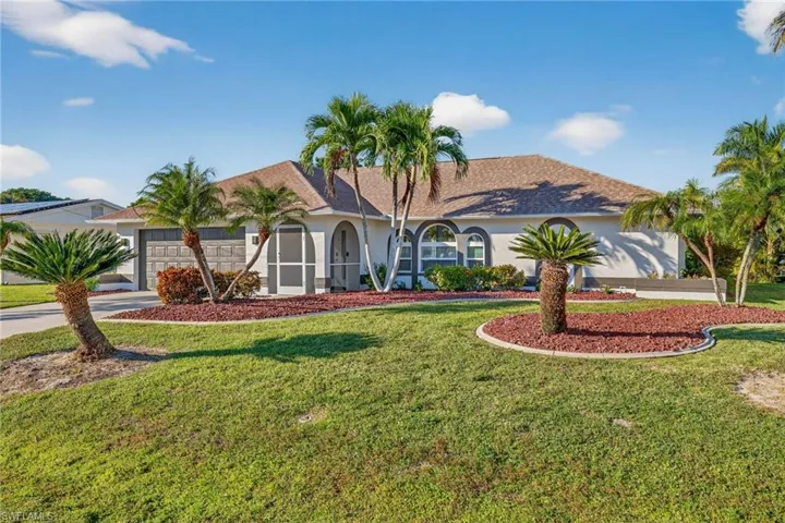 View of front of property with a shingled roof, stucco siding, concrete driveway, and a front lawn