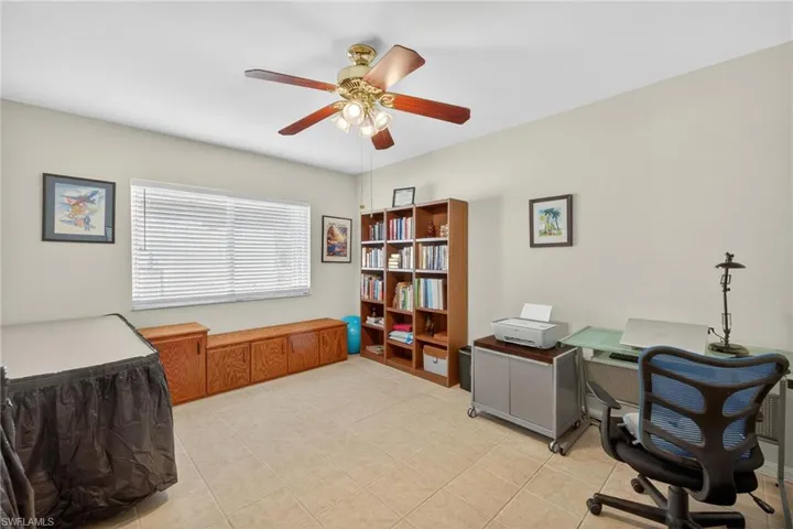 Office space featuring ceiling fan and light tile patterned floors