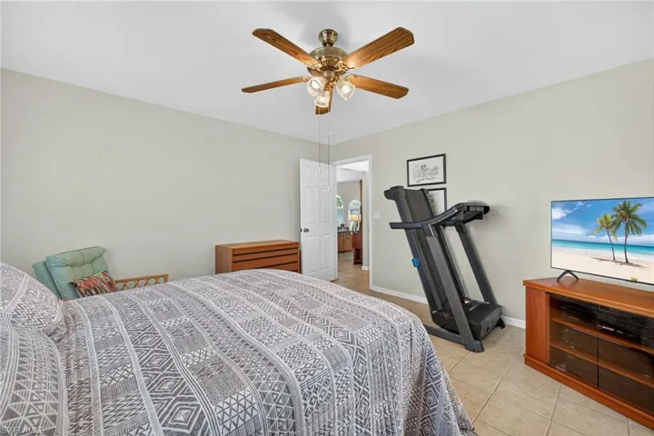 Bedroom featuring light tile patterned floors and ceiling fan