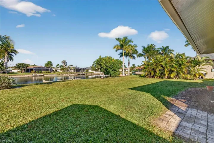 View of green lawn featuring a water view