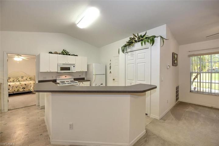 Another view of the kitchen with a raised bar.