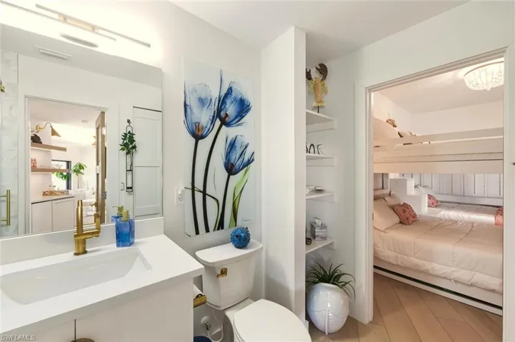 Ensuite bathroom featuring vanity and light wood-style floors