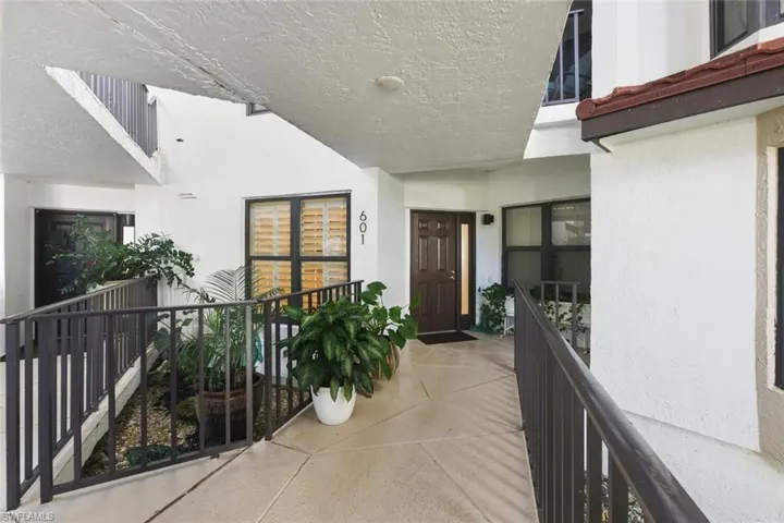 Property entrance featuring stucco siding