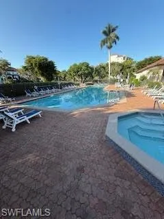 Community pool with a patio and a community hot tub
