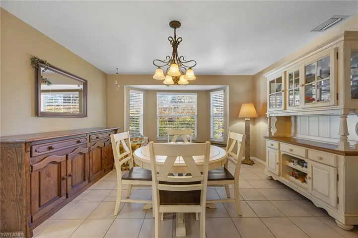 Dining room featuring a chandelier and light tile patterned floors
