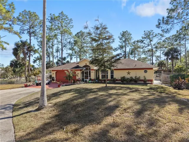 Ranch-style house featuring concrete driveway, roof with shingles, and a garage