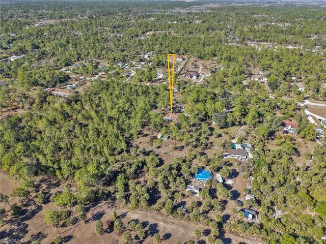View of property location featuring a forest