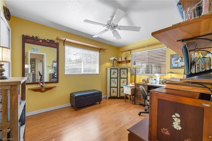 Office space with light wood-type flooring and a ceiling fan
