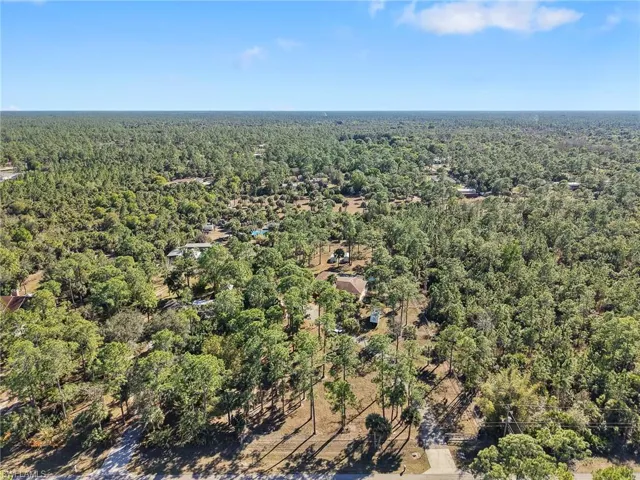 Aerial overview of property's location featuring a forest