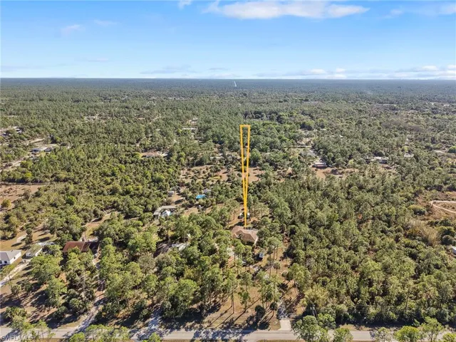 Aerial overview of property's location featuring a heavily wooded area