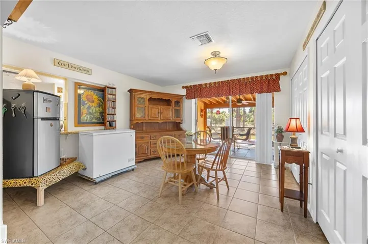 Dining area featuring light tile patterned flooring and a textured ceiling