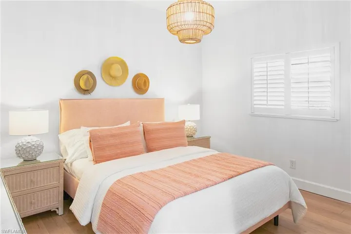 Bedroom featuring baseboards and wood finished floors
