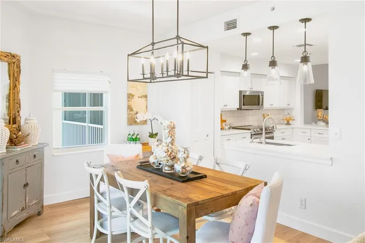 Dining room featuring recessed lighting, baseboards, an inviting chandelier, visible vents, and light wood-style floors