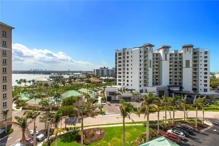 View of property with a view of city and uncovered parking