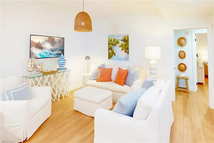 Living room with hardwood / wood-style flooring and baseboards