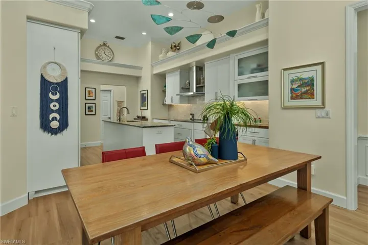 Dining space featuring crown molding, sink, and light wood-type flooring