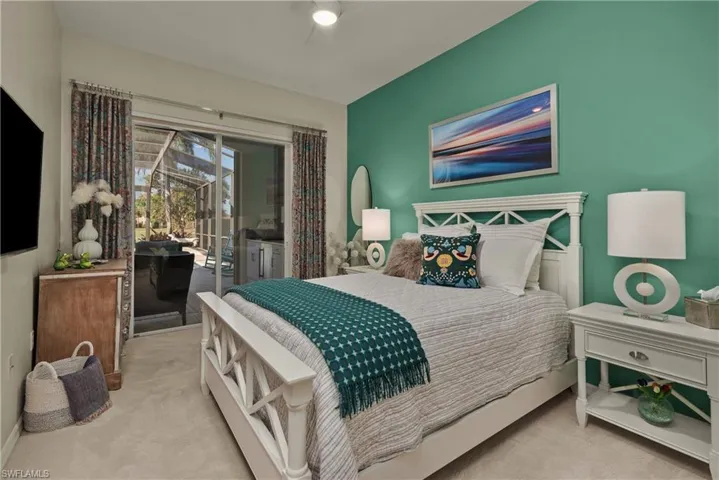 Bedroom with light carpet and access to exterior