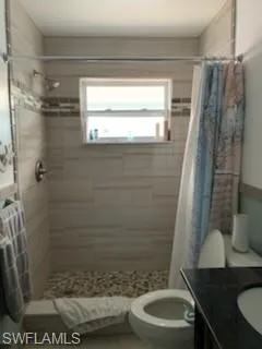 Bathroom featuring a shower stall and vanity